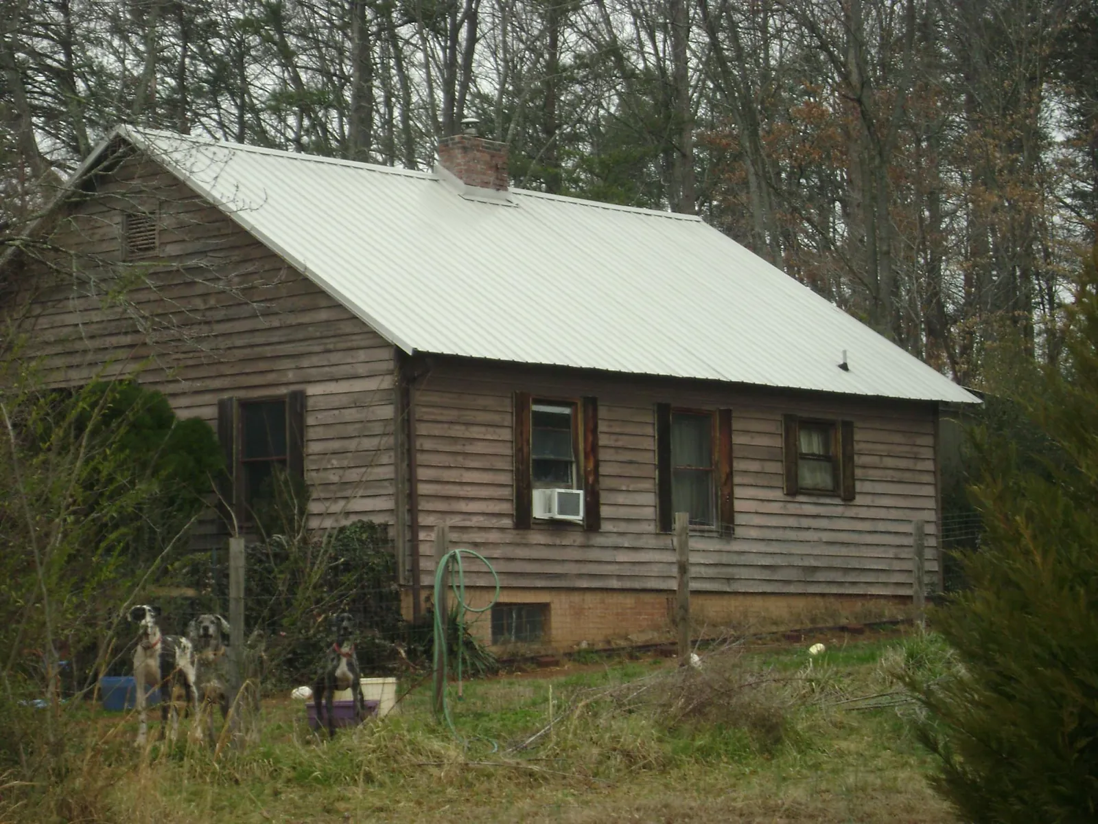 White metal roof on an old wood sided farmhouse, from a Metal Roof Installation job in Foristell